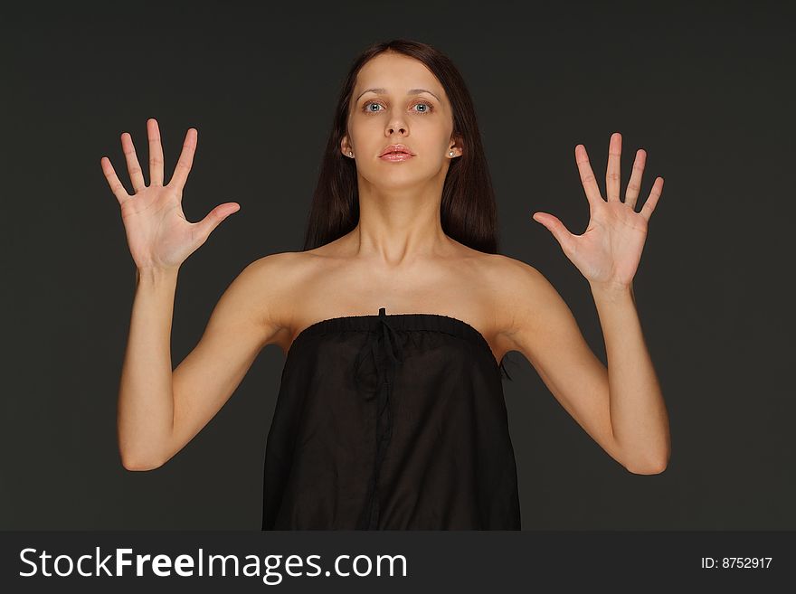 The young lonely woman on a dark background. The young lonely woman on a dark background