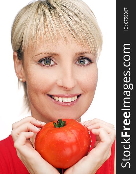 Blond girl with a ripe red tomato