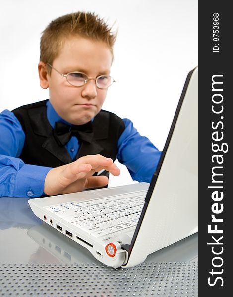 Funny school boy with with fingers on laptop keyboard. Funny school boy with with fingers on laptop keyboard