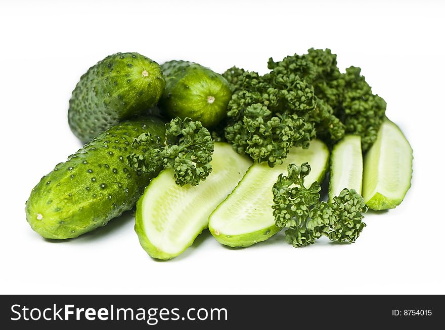 Cutted and whole  cucumbers and parsley, healthy food isolated on white