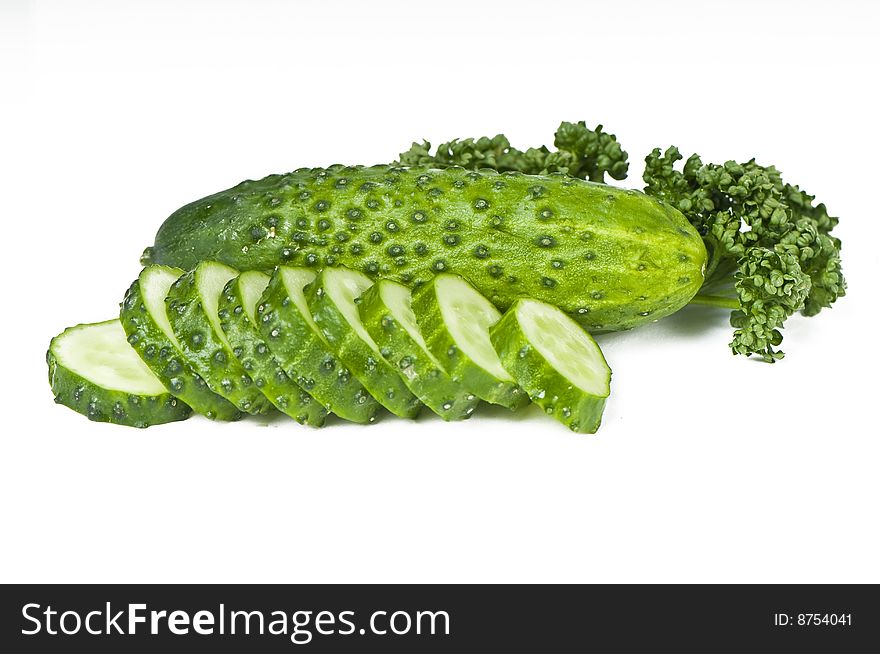 Cutted cucumbers and parsley, healthy food isolated on white. Cutted cucumbers and parsley, healthy food isolated on white