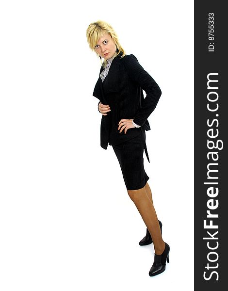 Full body view of young blond woman in business wear, black jacket, tailleur skirt and white blouse, black high heels shoes, isolated on white background. Full body view of young blond woman in business wear, black jacket, tailleur skirt and white blouse, black high heels shoes, isolated on white background.