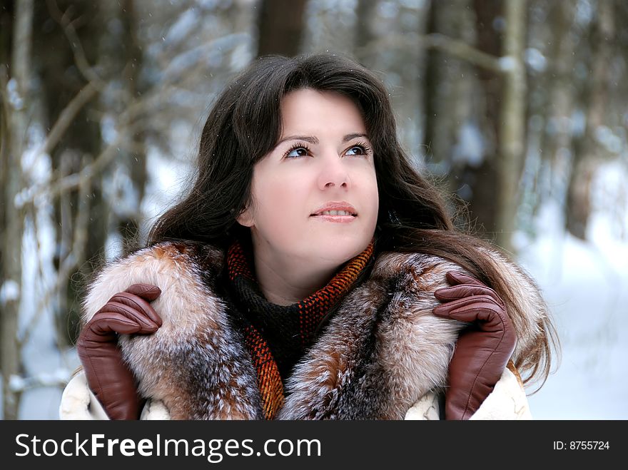 Portrait of a young girl in a fur coat in winter forest. Portrait of a young girl in a fur coat in winter forest.