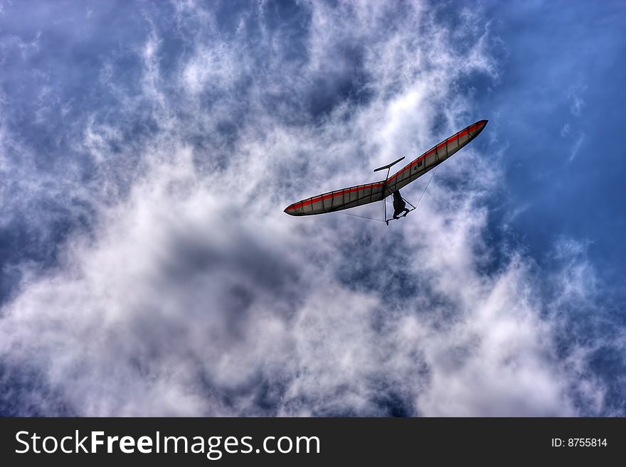 Man with flying wing on sky
