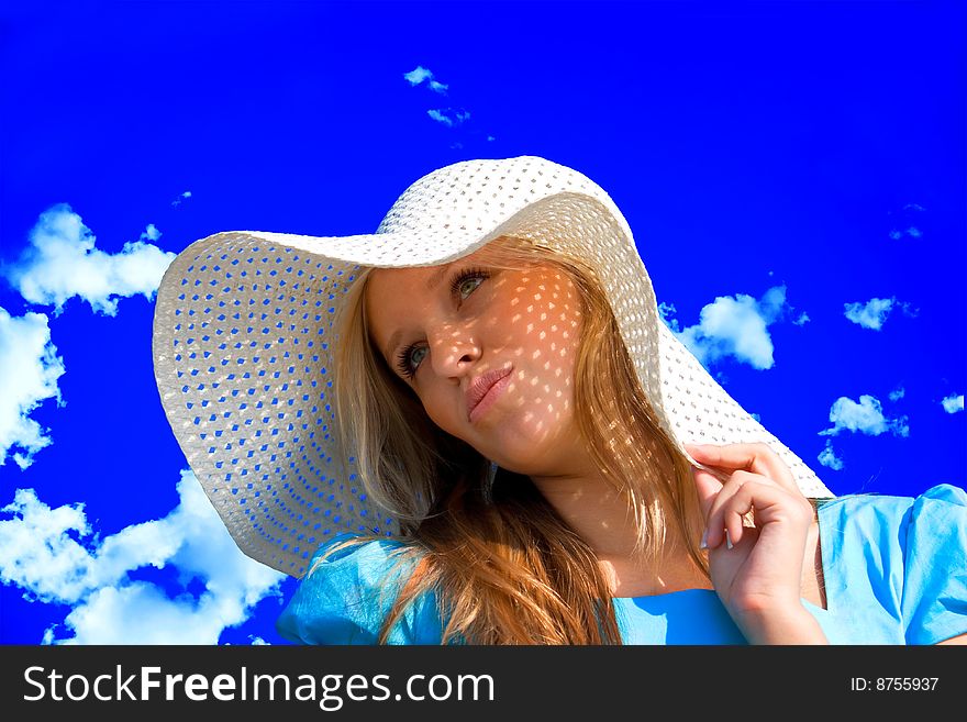 Young girl under hat in summer