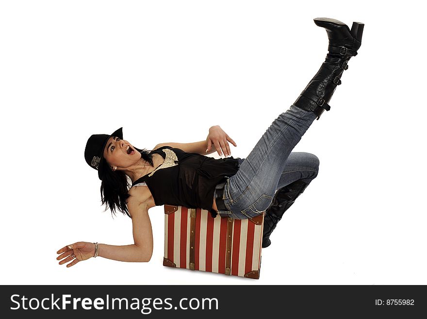 Full body view of attractive young woman walking or lying on a striped red and white suitcase with a black hat. Isolated on white. Full body view of attractive young woman walking or lying on a striped red and white suitcase with a black hat. Isolated on white.