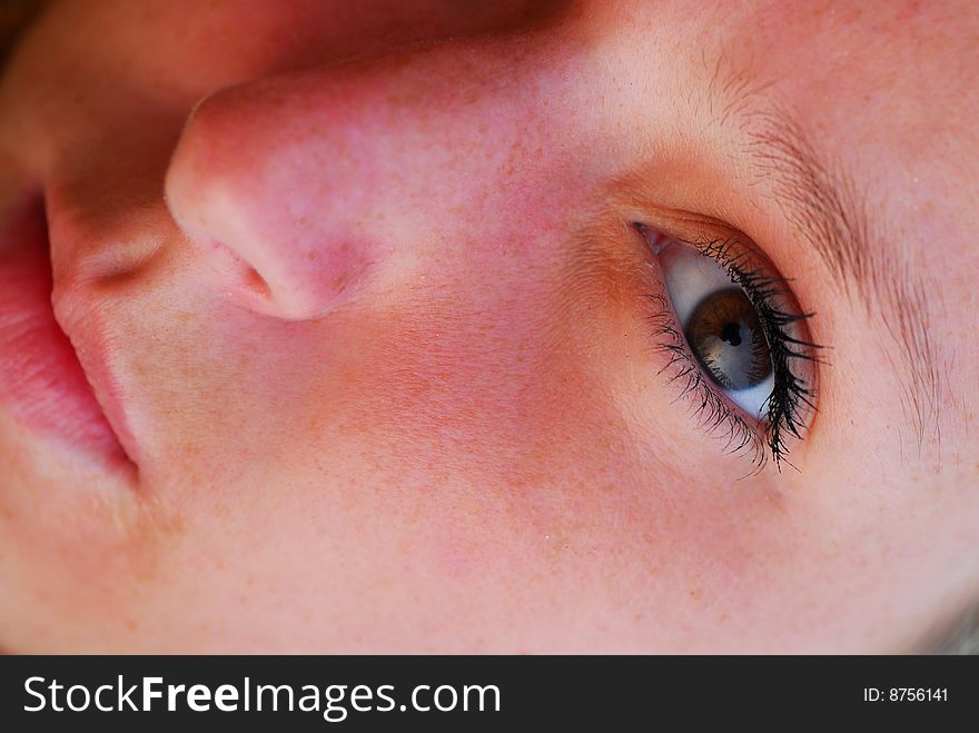 Tightly cropped face portrait of attractive young blond girl. Only half of the face is visible. Tightly cropped face portrait of attractive young blond girl. Only half of the face is visible