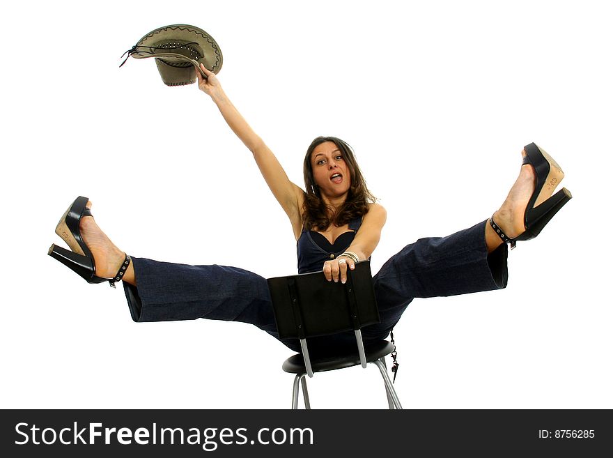 Full body view of funny young woman in cowboy wear, riding a high stool. Isolated on white background. Full body view of funny young woman in cowboy wear, riding a high stool. Isolated on white background.