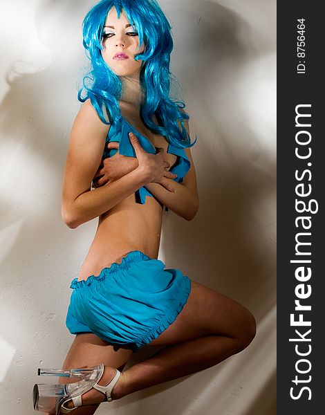Fancy looking beautiful naked woman with blue wig. Fancy looking beautiful naked woman with blue wig