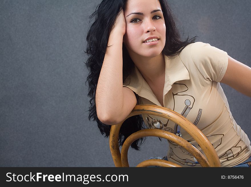 Young girl sitting in an old chair. Young girl sitting in an old chair