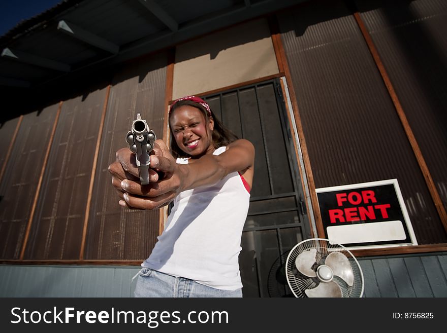 African American woman with a gun on her front porch. African American woman with a gun on her front porch