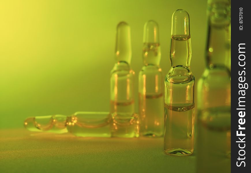 Colored vials on the green background