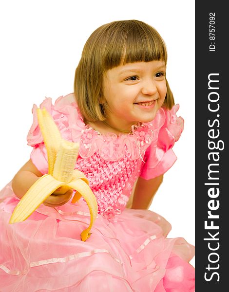 Young girl in pink dress with banana. Young girl in pink dress with banana
