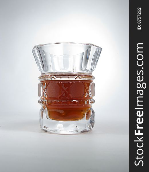 Glass with a drink on a grey background