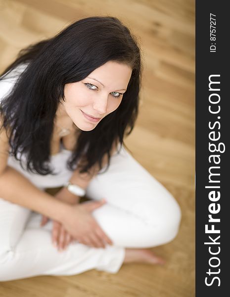 Young lady indoor sitting on floor in her new apartement. Young lady indoor sitting on floor in her new apartement