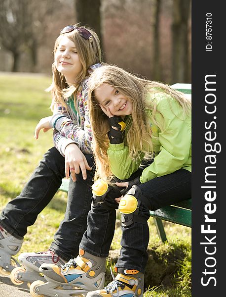 Two Happy Grils Sitting On Bench