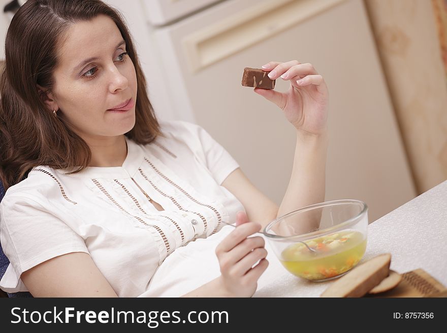 A photo of woman looking at chocolate while on a diet