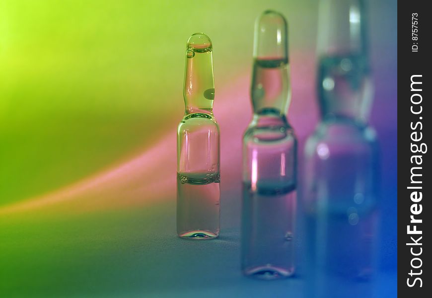 Colored vials on the green background