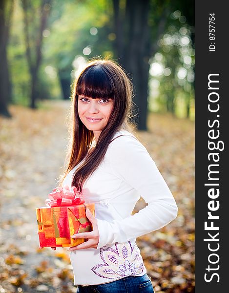 Young girl outside with gift boxes, selective focus. Young girl outside with gift boxes, selective focus