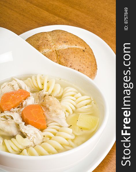 Wholesome chicken soup with pasta, carrots, potatoes and herbs. Wholesome chicken soup with pasta, carrots, potatoes and herbs.