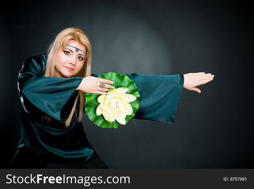 Woman with lotus, studio shot