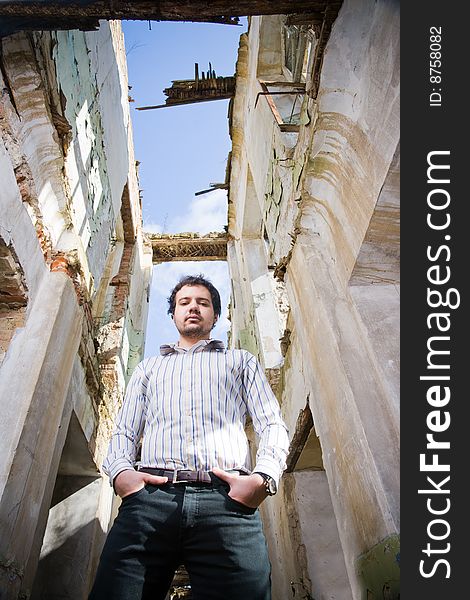 Young stylish man in abandoned building, low angle of view