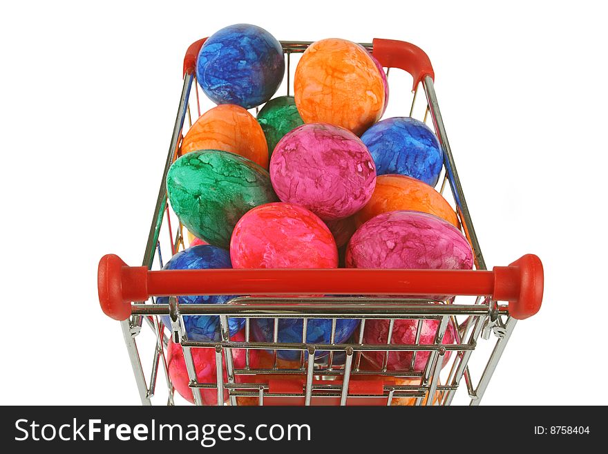 Colorful easter eggs in a shopping trolley on white background