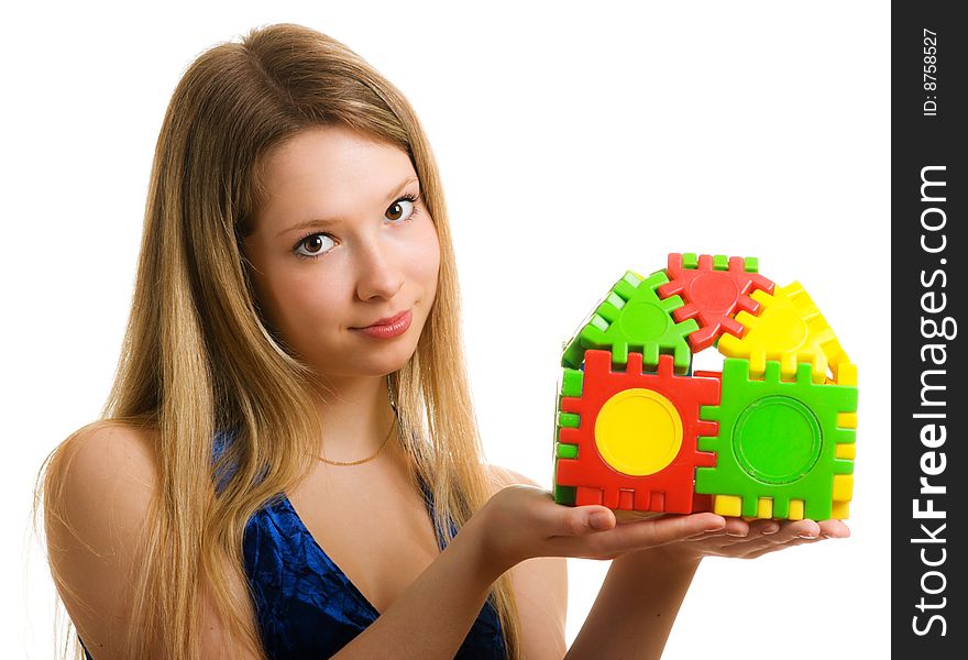 Beautiful girl with a toy house in the hands