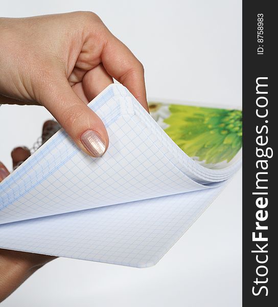 An isolated to White image of a held Notepad. An isolated to White image of a held Notepad