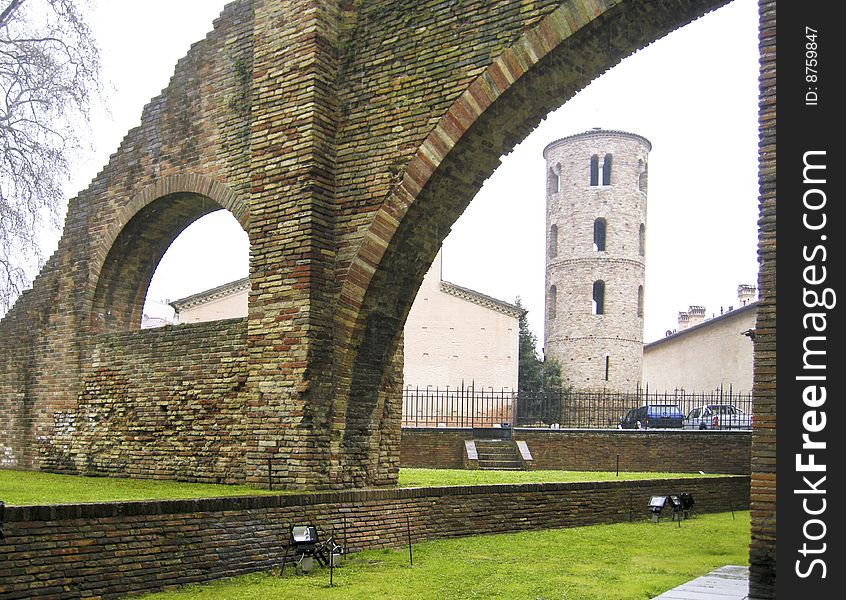 External walls of the Byzantine cathedral of Saint Apollinare and Medieval bell tower in the background, in Ravenna, Italy. External walls of the Byzantine cathedral of Saint Apollinare and Medieval bell tower in the background, in Ravenna, Italy.