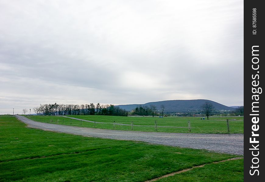 Trail In Park By Green Grass