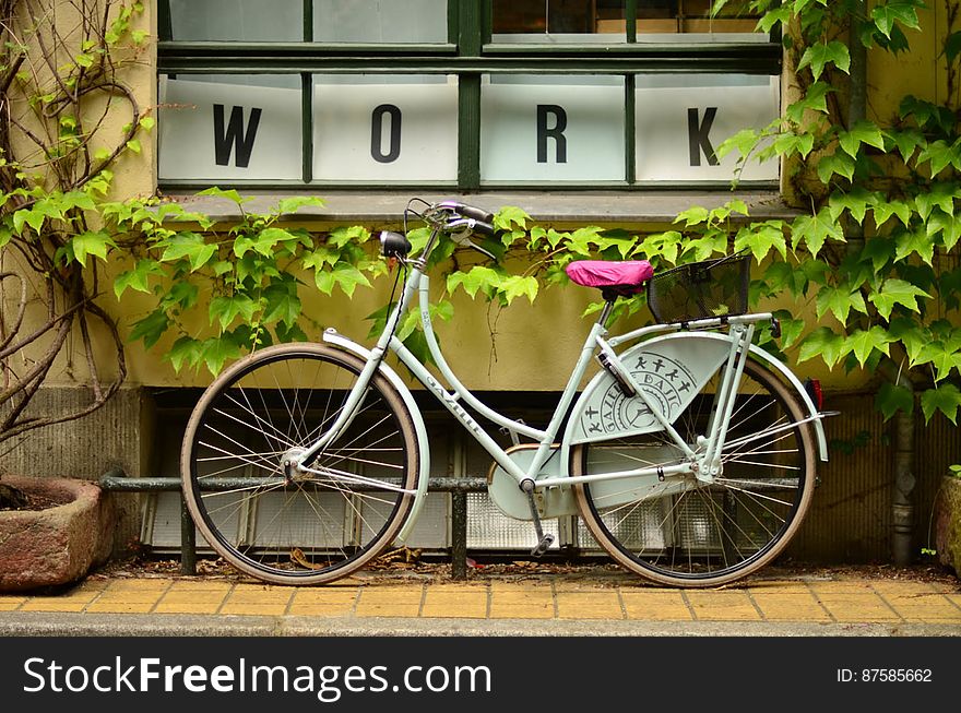 Bicycle Outside Window With Work Sign