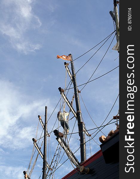 Lone seaman (not a real person)climbs up the ship's mast on the highseas.  All in a days work?. Lone seaman (not a real person)climbs up the ship's mast on the highseas.  All in a days work?