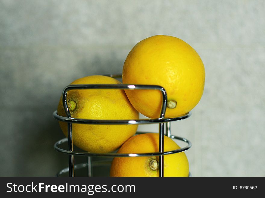 Three lemons against a gray background. Three lemons against a gray background