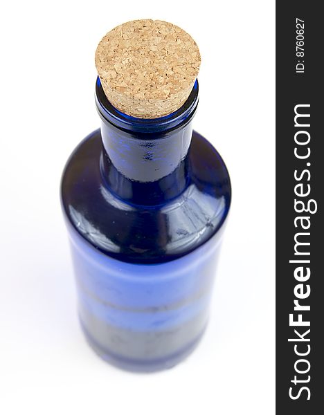 Blue bottle with a cork on a white background
