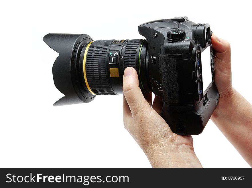 Black digital camera in hands isolated on white