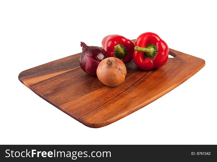 Onions and peppers on cutting board isolated on white background. Onions and peppers on cutting board isolated on white background