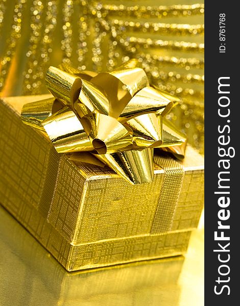 Gift box on golden background