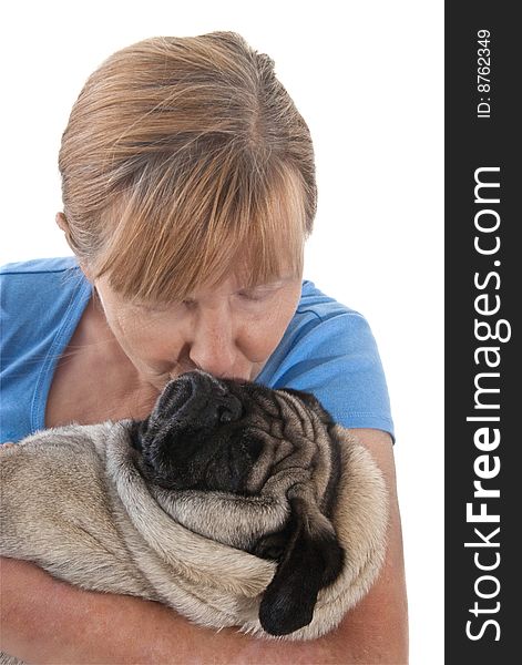 Mature Lady Cuddling a Pug Dog, Isolated on a White Background. Mature Lady Cuddling a Pug Dog, Isolated on a White Background