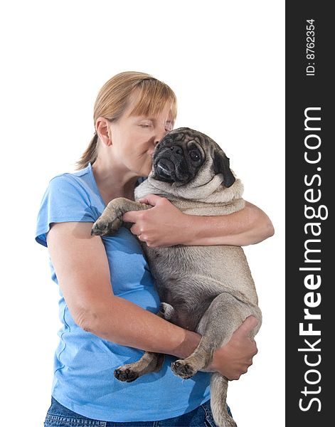 Mature Lady Cuddling a Pug Dog, Isolated on a White Background. Mature Lady Cuddling a Pug Dog, Isolated on a White Background