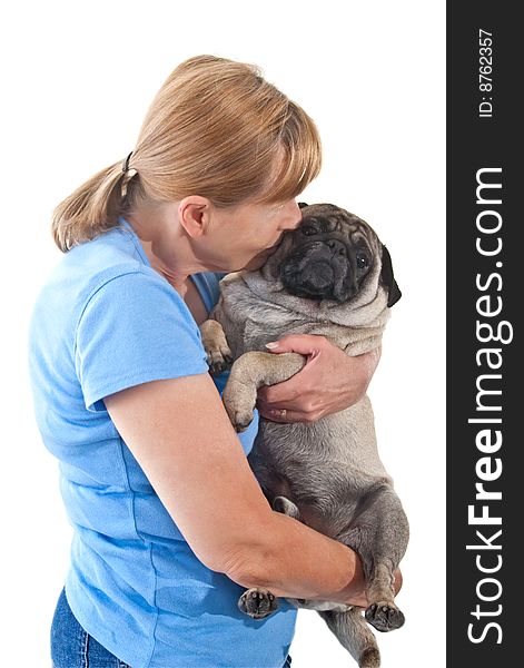 Mature Lady Cuddling a Pug Dog, Isolated on a White Background. Mature Lady Cuddling a Pug Dog, Isolated on a White Background