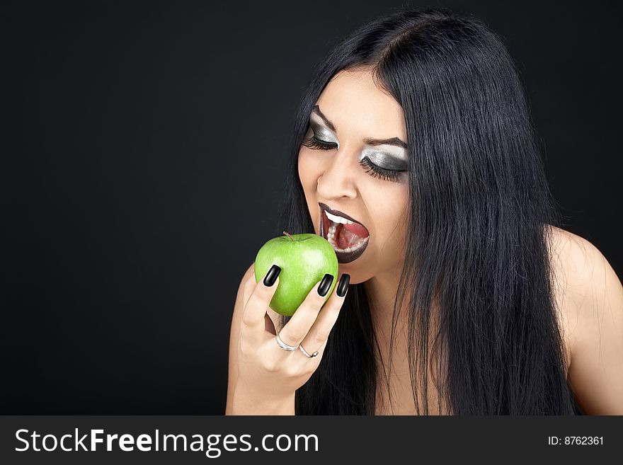 Brunette eating a green apple. Brunette eating a green apple