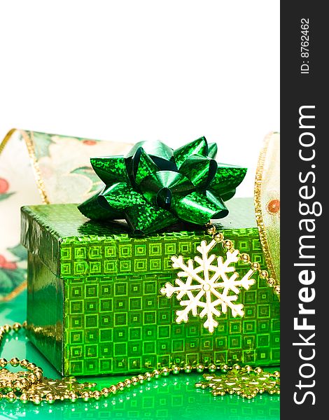 Green gift box and snowflake with ribbon