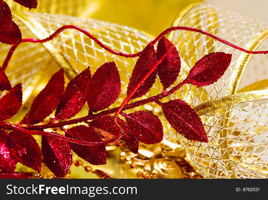 Red festive sprig on golden background