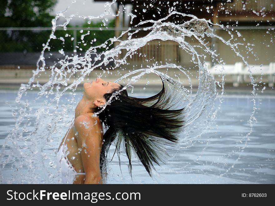 Beautiful woman rising out of water, with hair flying and spiraling arcs of water. Beautiful woman rising out of water, with hair flying and spiraling arcs of water