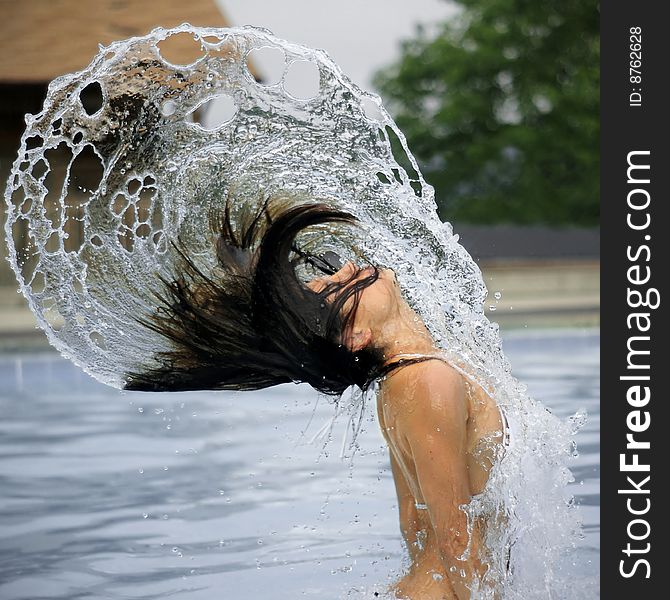 Beautiful woman rising out of water, with hair flying and spiraling arcs of water. Beautiful woman rising out of water, with hair flying and spiraling arcs of water