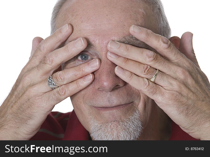 Playful old man spying through his fingers. Playful old man spying through his fingers