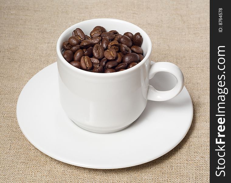 Coffee beans in white cup. Coffee beans in white cup