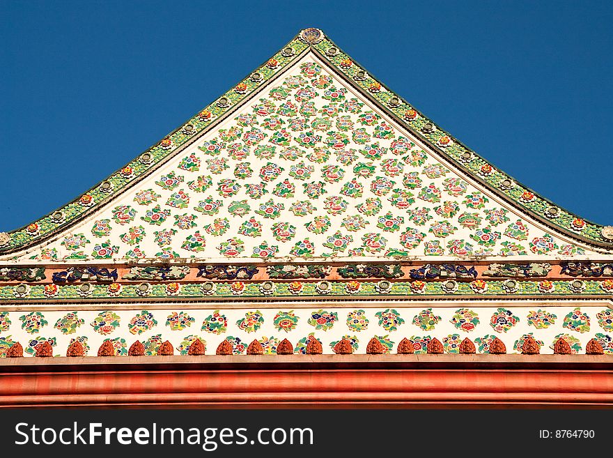 Traditional Thai art of mosaic decoration on top front of Buddhist church, Bangkok, Thailand. Traditional Thai art of mosaic decoration on top front of Buddhist church, Bangkok, Thailand