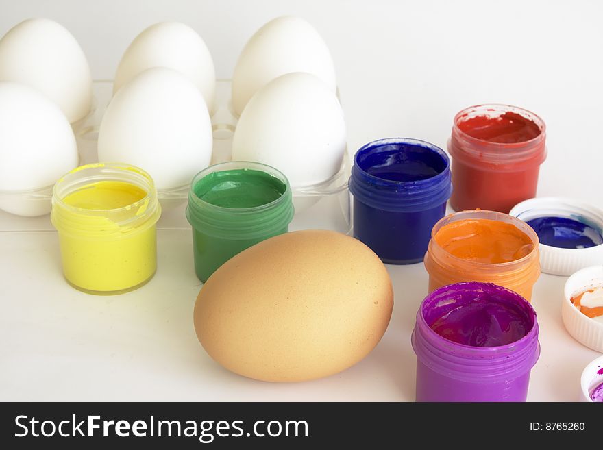 Eggs and paints, preparation for easter on white